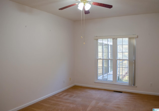 empty room with light colored carpet and ceiling fan