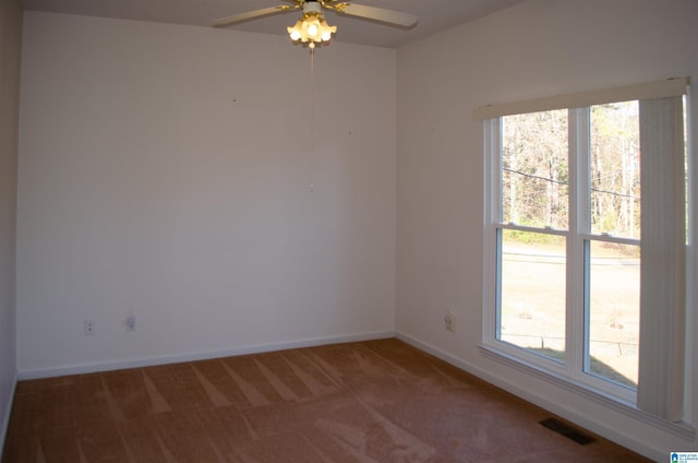 carpeted spare room featuring ceiling fan