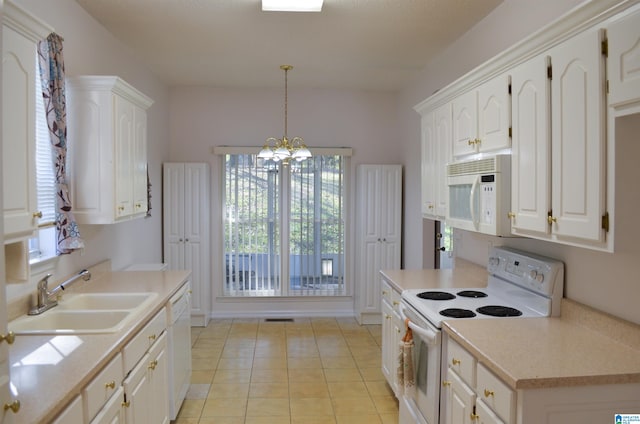 kitchen with pendant lighting, sink, white appliances, light tile patterned floors, and white cabinetry