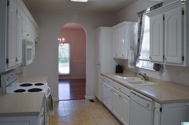 kitchen with white cabinetry, white appliances, sink, and light tile patterned floors