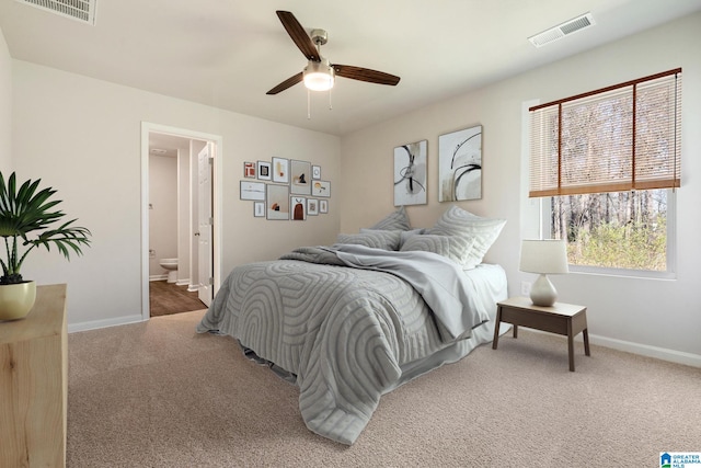 bedroom featuring carpet flooring, ensuite bathroom, and ceiling fan