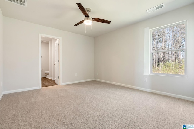 carpeted spare room with ceiling fan