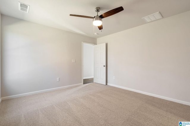 carpeted empty room featuring ceiling fan