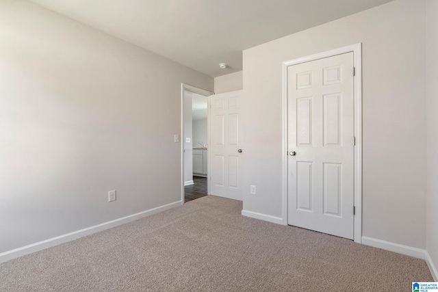 unfurnished bedroom with dark carpet