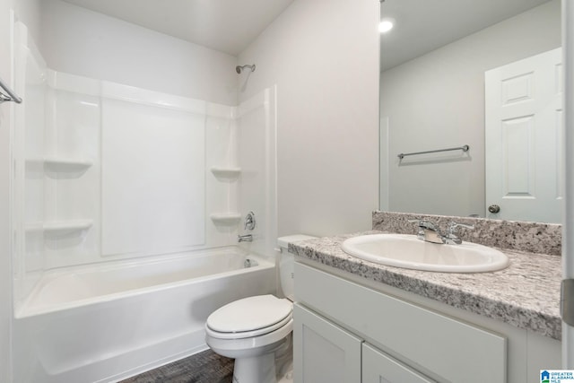 full bathroom with hardwood / wood-style flooring, vanity,  shower combination, and toilet