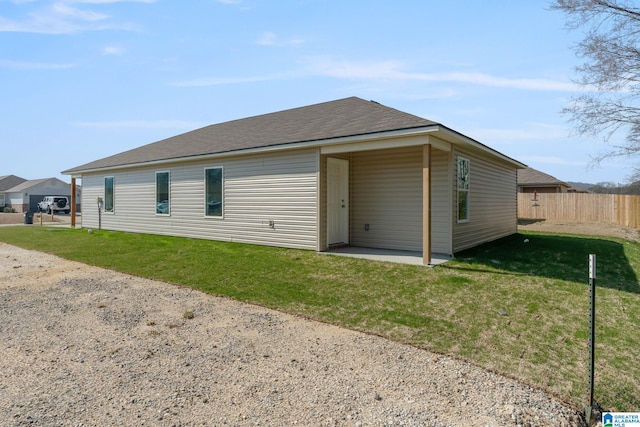 rear view of house with a lawn and a patio area