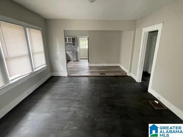 spare room with dark hardwood / wood-style flooring