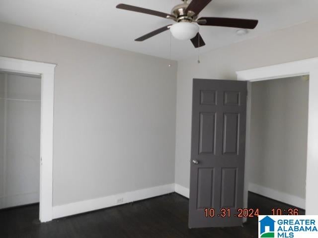 unfurnished bedroom with a closet, ceiling fan, and dark wood-type flooring