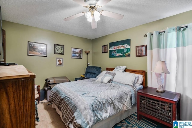 bedroom featuring ceiling fan, light colored carpet, and a textured ceiling