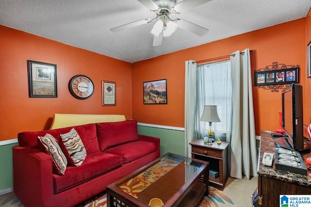 carpeted living room with ceiling fan and a textured ceiling