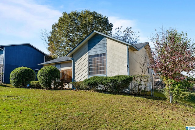 view of home's exterior with a yard and a wooden deck