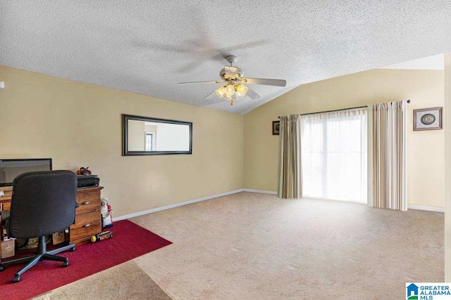 office area featuring ceiling fan, light colored carpet, lofted ceiling, and a textured ceiling