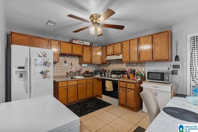 kitchen featuring ceiling fan, a textured ceiling, white fridge with ice dispenser, and electric stove