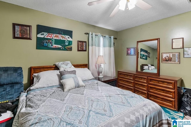 bedroom with ceiling fan and a textured ceiling