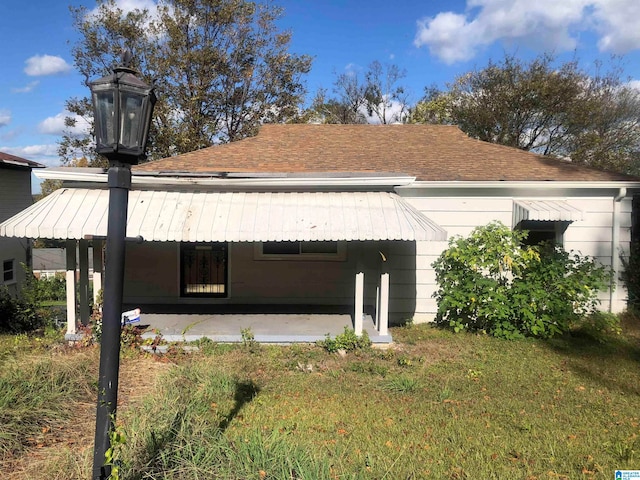 rear view of property with a lawn