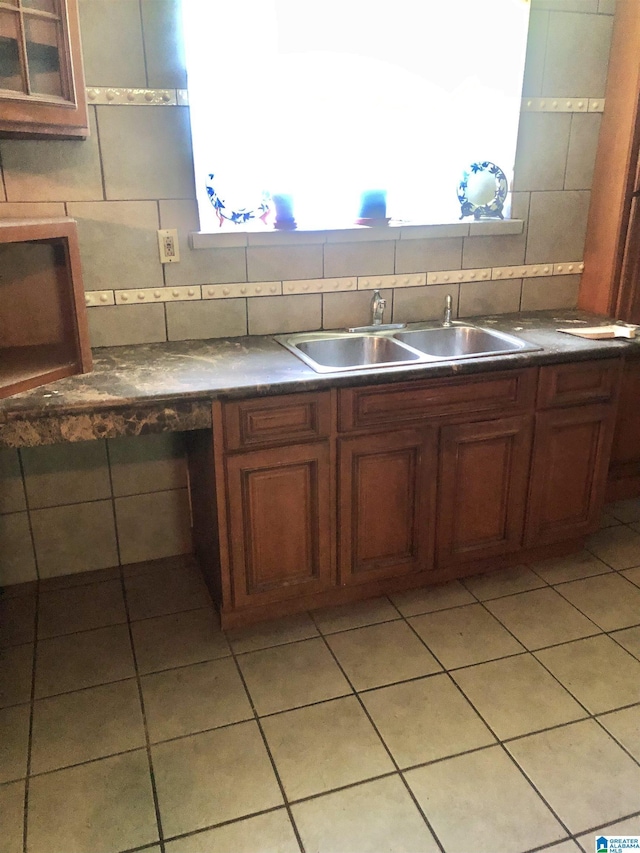 2724 20th Pl, Ensley, Birmingham, AL 35208 - kitchen featuring a sink, backsplash, light tile patterned floors, and dark countertops