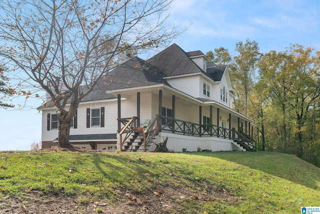 view of front of house with a front yard and a porch