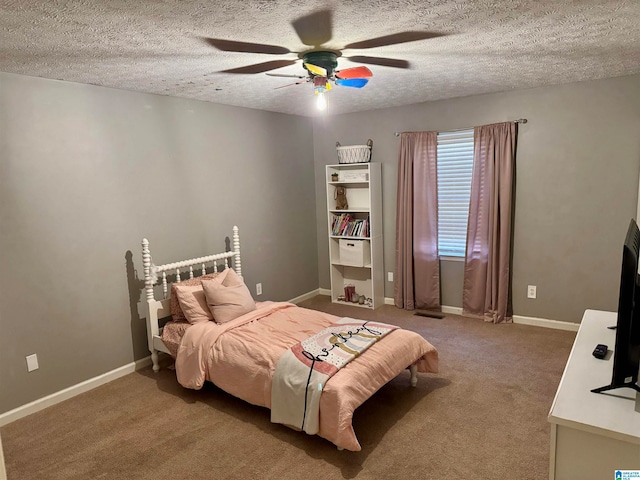 carpeted bedroom featuring ceiling fan and a textured ceiling