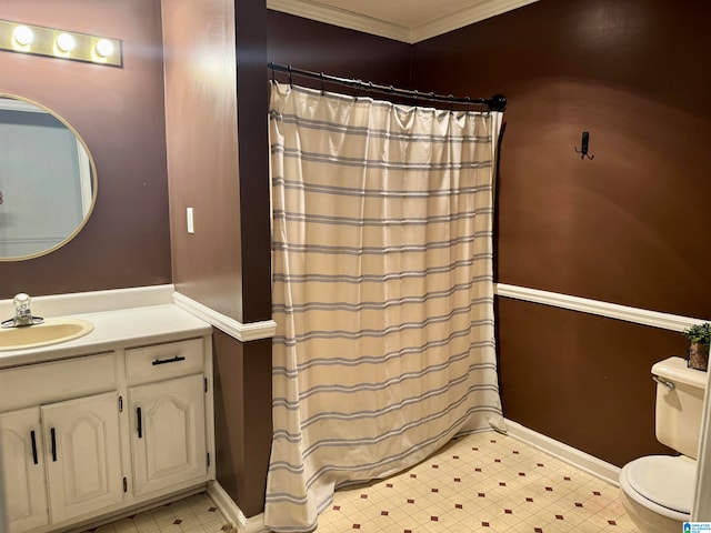 bathroom with toilet, vanity, and ornamental molding