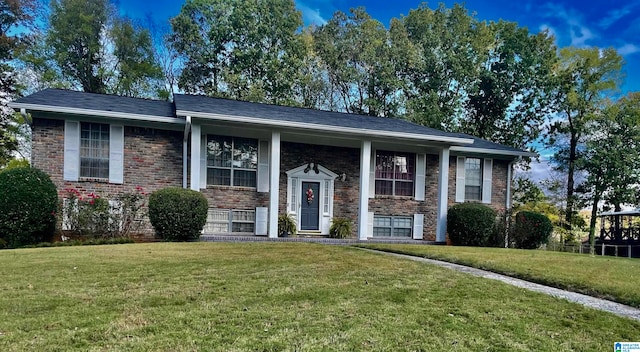 split foyer home with a front lawn