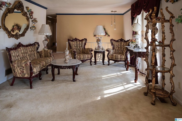 living area with crown molding and carpet