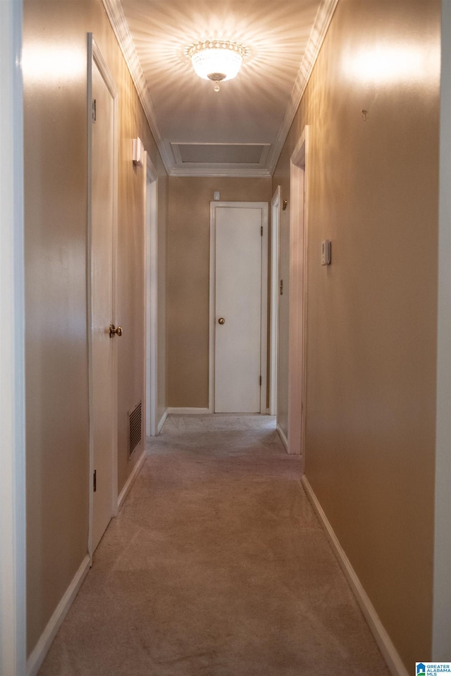 corridor featuring ornamental molding and light carpet