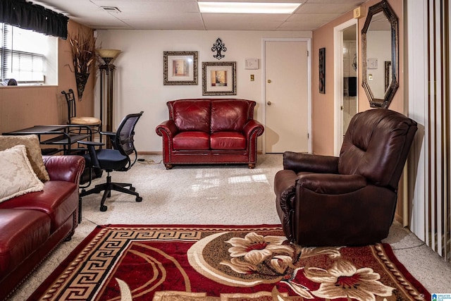 living room featuring a drop ceiling