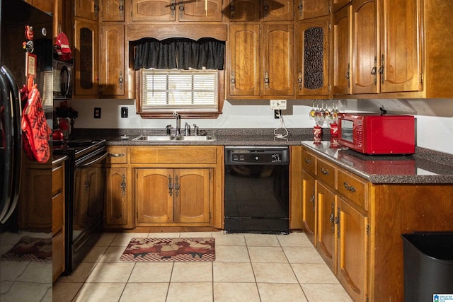 kitchen featuring sink, light tile patterned floors, and black appliances