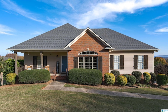 view of front of house with a porch and a front yard