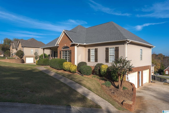 view of front of house featuring a garage and a front lawn