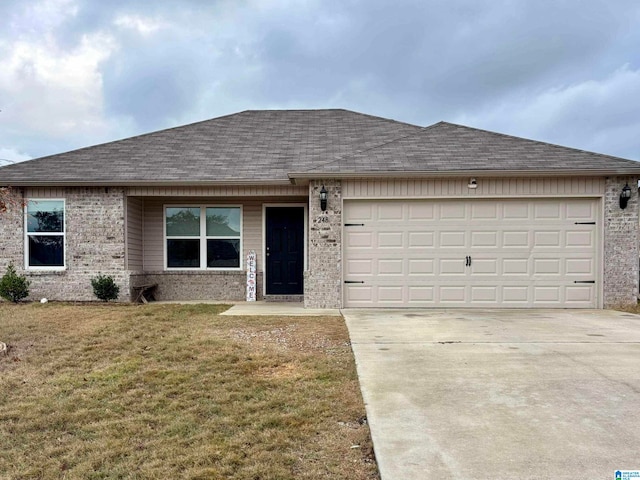 ranch-style house with a garage and a front lawn