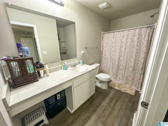 bathroom with hardwood / wood-style floors, vanity, and toilet