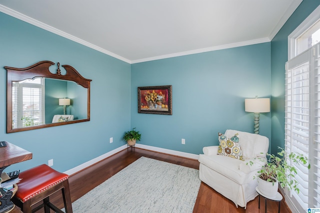 living area with crown molding, plenty of natural light, and hardwood / wood-style flooring