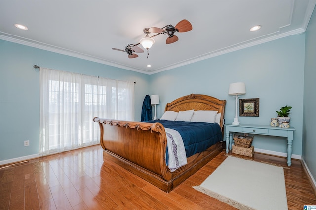 bedroom featuring ceiling fan, wood-type flooring, and ornamental molding