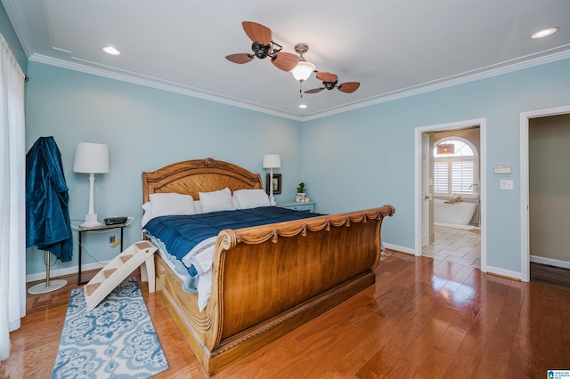 bedroom with hardwood / wood-style flooring, ensuite bath, ceiling fan, and ornamental molding