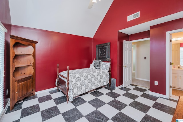 bedroom with ceiling fan, high vaulted ceiling, and ensuite bath