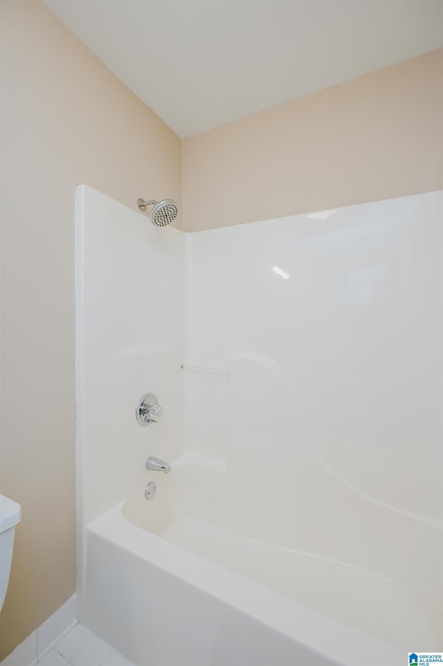 bathroom with bathtub / shower combination, tile patterned floors, and toilet