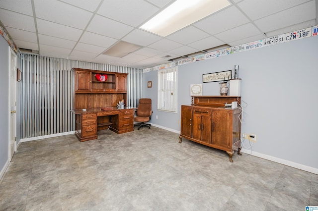 office area with a paneled ceiling