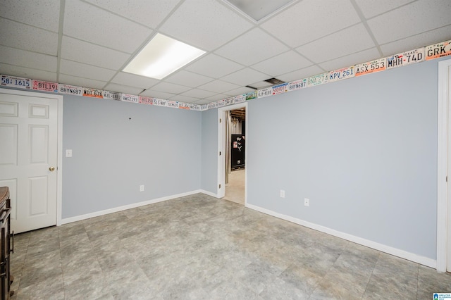 empty room featuring a drop ceiling