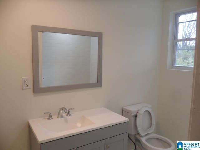 bathroom featuring vanity and toilet