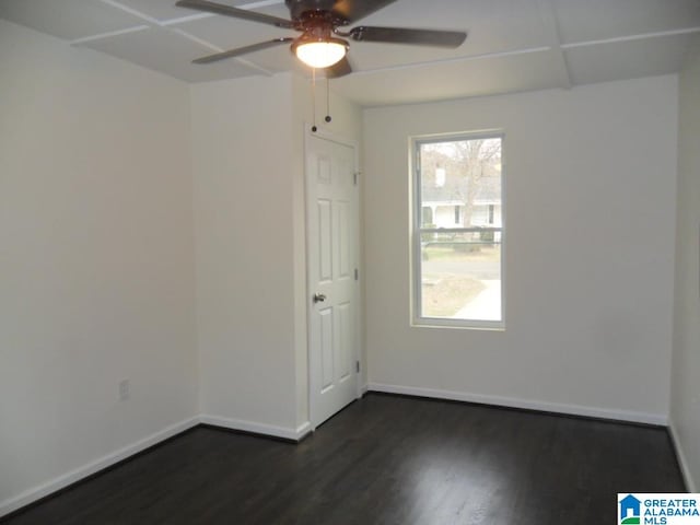 unfurnished room with ceiling fan and dark wood-type flooring