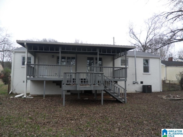 back of house with a porch and central AC