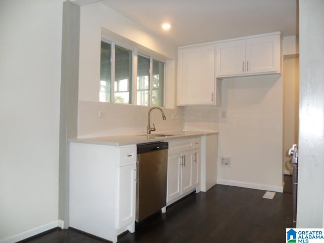 kitchen with white cabinetry, sink, dark wood-type flooring, stainless steel dishwasher, and backsplash