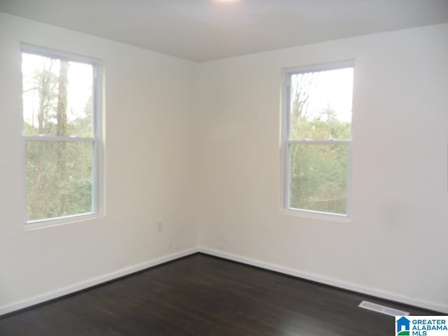 unfurnished room featuring dark hardwood / wood-style floors