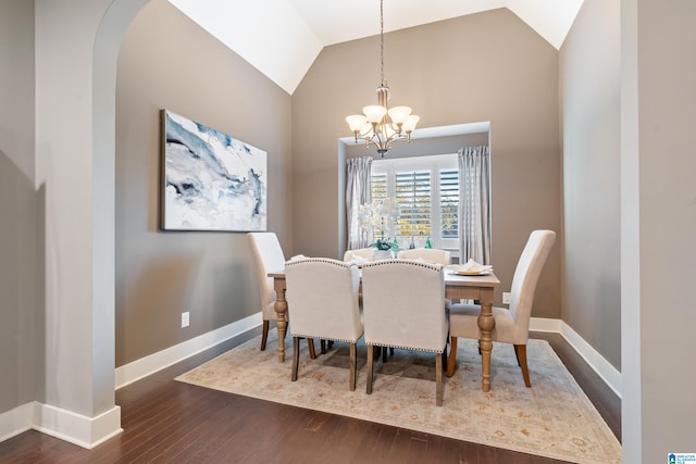 dining area with a chandelier, dark hardwood / wood-style flooring, and lofted ceiling