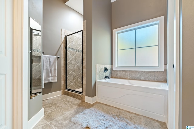 bathroom with tile patterned flooring and shower with separate bathtub