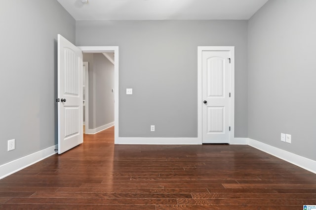 unfurnished bedroom featuring dark hardwood / wood-style flooring