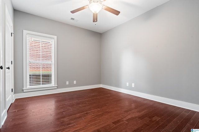 spare room featuring ceiling fan and dark hardwood / wood-style flooring