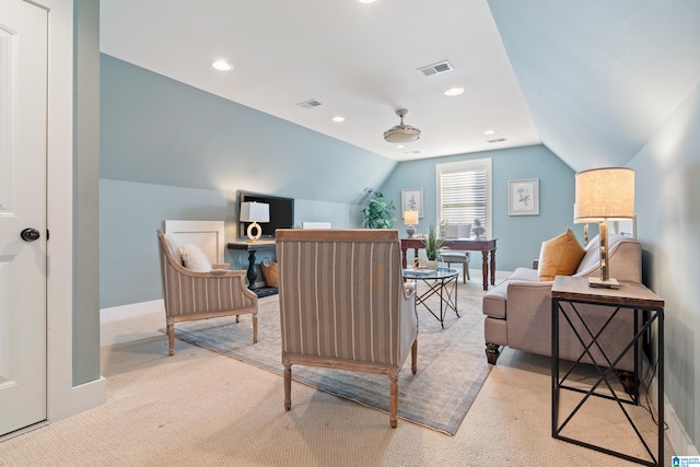 living area with lofted ceiling and light carpet