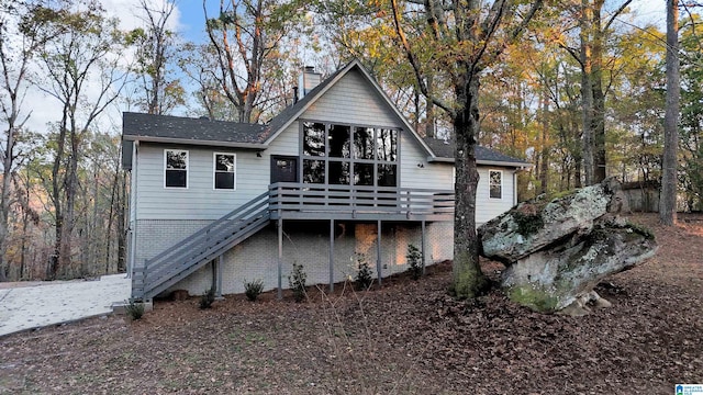 back of house featuring a wooden deck